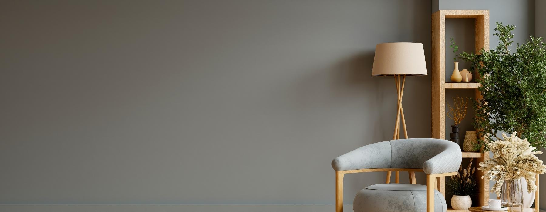 a wall with a lamp and a chair
